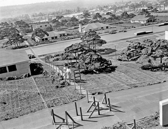 Boeing employees Joyce Howe and Susan Heidrich ascend a “hill” on a wooden walkway for a better view of Wonderland. Note the “cars” on the street. Their angular shape makes them look more like AMC Gremlins from the 1970s than the smoothly rounded Fords and Chevies of the 1940s.