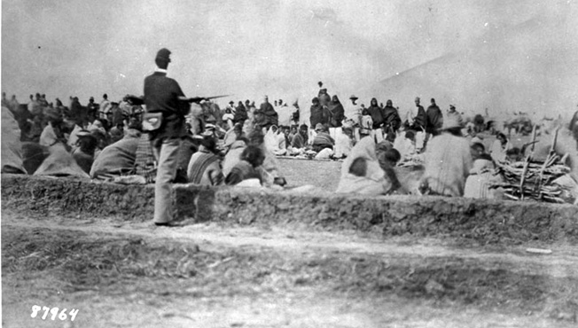 A soldier guards Navajos who surrendered to Carson in 1864 at Fort Sumner. Carson was brevetted a brigadier general in 1866, but by then he was in poor health and died two years later.