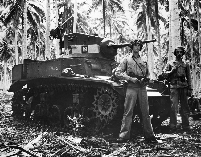 Two tankers pose beside their M5 Stuart light tank used in the Battle of Tenaru, site of one of the Pacific’s fiercest battles. 