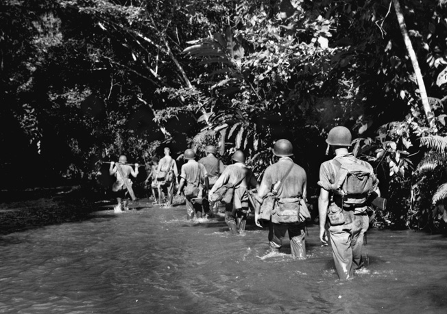 American Marines wade through Alligator Creek, not far from the Tenaru River, on the hunt for the enemy.