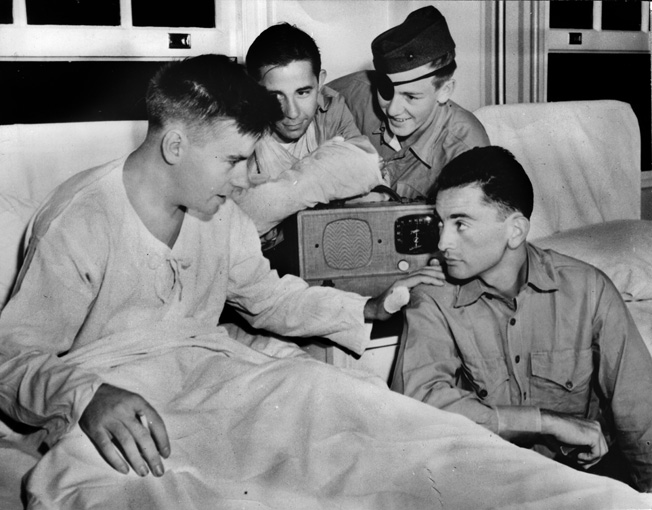 Marine Al Schmid, left, photographed in the hospital, was blinded when a grenade exploded in his machine gun pit; he continued firing until relieved. For his courage he received the Navy Cross. 