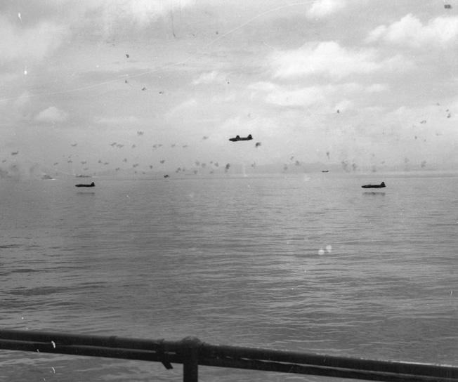 Japanese Mitsubishi G4M “Betty” bombers skim the water during an attack on American transport ships the day after the Marine landing.