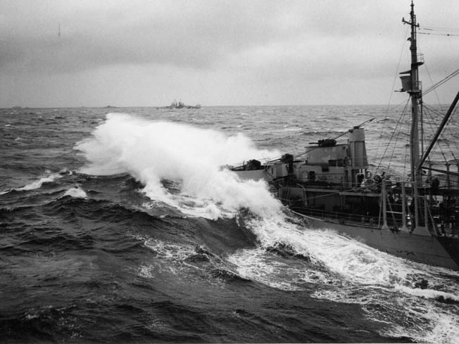 Heavy seas break over the bow of a U.S. Navy fleet oiler during refueling operations as Typhoon Cobra ravaged the U.S. Third Fleet. The oiler was attempting to provide fuel for the aircraft carrier USS Enterprise.