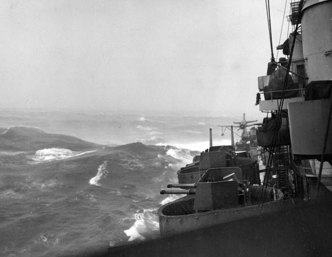 Angry waves and winds buffet the cruiser USS Pittsburgh during Typhoon Connie in June 1945. The Pittsburgh was heavily damaged during the storm, losing more than 100 feet of its bow to the powerful typhoon. 