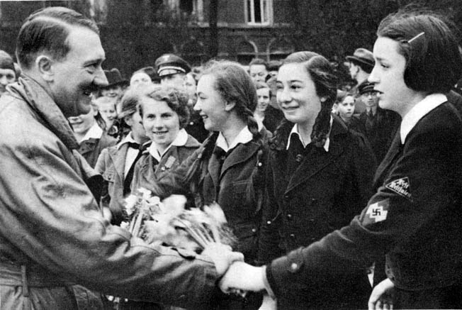 Hitler greets adoring members of the Bund Deutscher Mädel (BDM), the Nazi Party-sponsored youth organization for young German women. 
