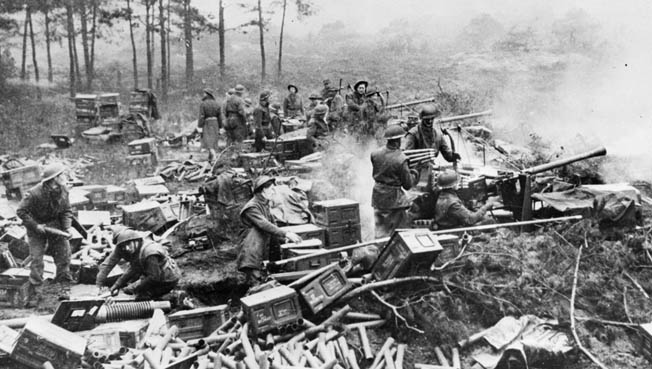 A massed battery of Allied 40mm Bofors guns fires in support of the Canadian advance into Belgium. The Swedish-made gun was primarily an antiaircraft weapon but was also effective as a direct-fire weapon.