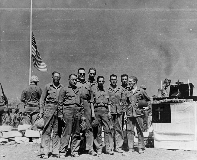 Fourth Marine Division chaplains on Iwo Jima following services at 4th Marine Division Cemetery (left to right): George C. Strum, Howard V. Sartell, Sneary (first name unknown), Roger W. Barney, E. Gage Hotaling, John H. Craven, Wilson H. Singer, Harry C. Wood.