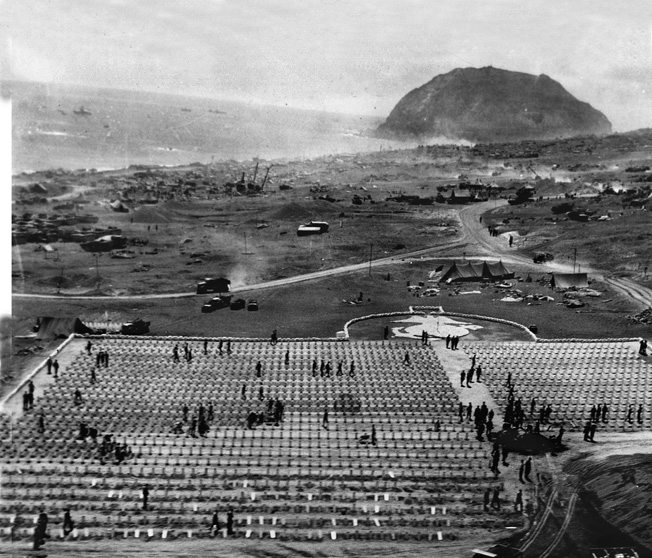 Aerial view of the 3rd and 4th Marine Division cemetery on Iwo Jima, with Mt. Suribachi in the background. Another cemetery on Iwo Jima, for the 5th Marine Division, held over 2,200 graves. Nearly 7,000 U.S. Marines died in over a month of furious fighting. 