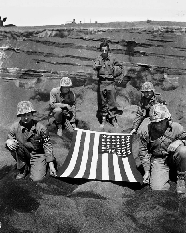 “You have gallantly given your life on foreign soil in order that others might live. Now we commit your body to the ground,” said Chaplain Hotaling, photographed at a committal service for a fallen Marine on Iwo Jima. 