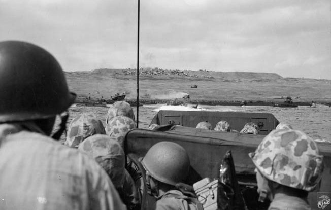U.S. Marines keep low aboard their landing craft as they approach the beaches of Iwo Jima. 