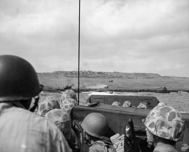 U.S. Marines keep low aboard their landing craft as they approach the beaches of Iwo Jima.