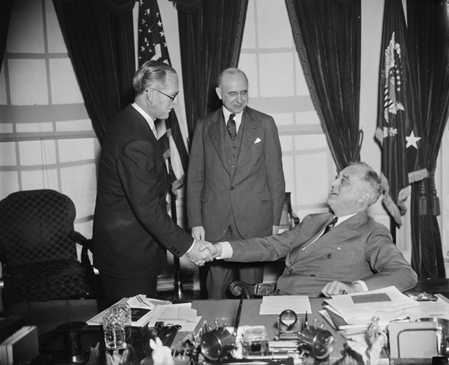 President Franklin D. Roosevelt (seated) congratulates Joseph P. Kennedy on becoming the new ambassador to Great Britain, January 1938. Associate Justice Stanley Reed, center, administered Kennedy’s oath. Because of intemperate remarks, Kennedy’s ambassadorship lasted less than three years.