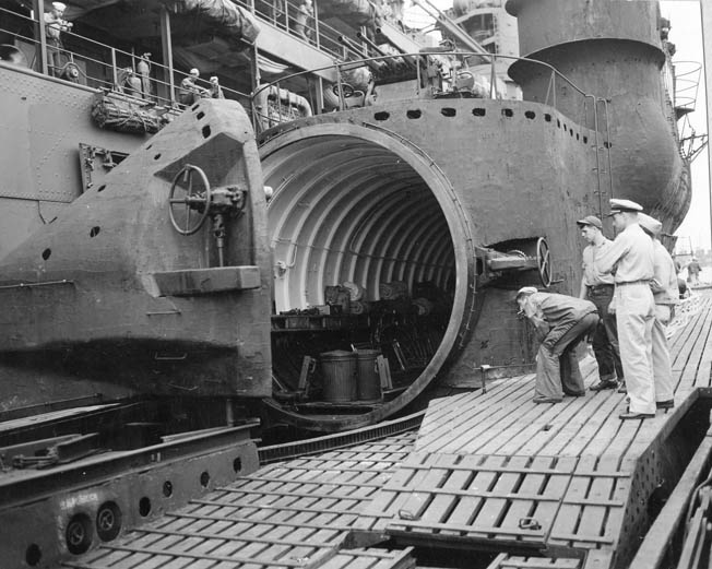 American naval personnel inspect the hangar of a Japanese submarine aircraft carrier. The hangar tube was sealed by a two-inch-thick rubber gasket, and the hatch could be opened hydraulically from inside.