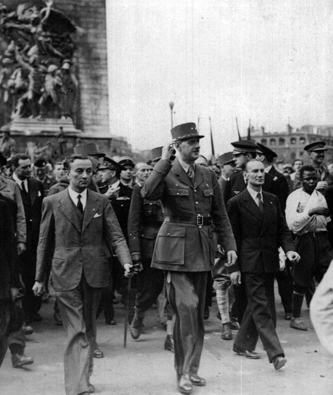 A beaming General de Gaulle marches down the Champs-Elysses. Top aide Alexandre Parodi is on his left. 