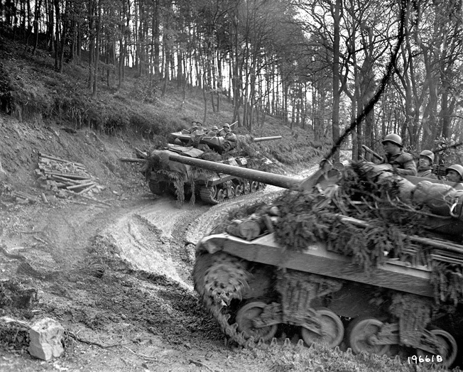 American armored vehicles make their way up a slippery incline in the HÃ¼rtgen Forest. The men of the 2nd Ranger Battalion relieved elements of the 5th Armored Division when they arrived at Hill 400. 