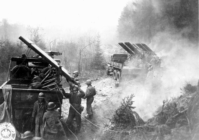 Men of the 18th Field Artillery Battalion, V Corps reload their rocket launchers in the HÃ¼rtgen Forest. Accurate and deadly American artillery fire was instrumental in holding the positions of the 2nd Ranger Battalion on Hill 400. 