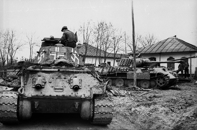 Photographed somewhere in the Ukraine, a captured Soviet T-34 medium tank has been pressed into service with the German Army and painted with swastikas and a white cross for recognition purposes.