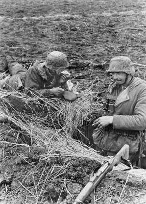 Tarnopol, Ukraine: 1944. German Soldiers in their Emplacement near Ternopil. German soldiers have a meal in their emplacement in the median sector of the Eastern Front. ©SZ Photo / Scherl / The Image Works NOTE: The copyright notice must include "The Image Works" DO NOT SHORTEN THE NAME OF THE COMPANY