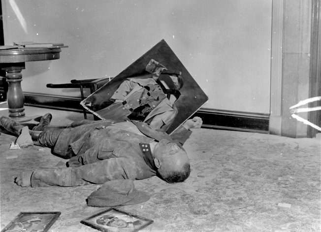 Volkssturm battalion commander Major Walter Dönicke also took his own life on April 19 in Leipzig city hall rather than surrender. Someone has propped a torn portrait of Hitler next to his body. 