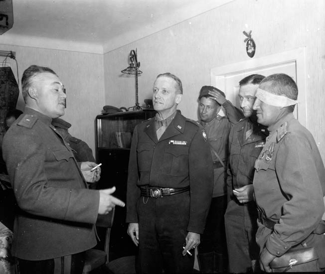 Maj. Gen. Stanley E. Reinhart (center), commander of the 65th Division, meets with his Russian counterpart, commander of the 7th Guards Parachute Division, after their units linked up at Erlauf, Austria, and they learned of Germany’s surrender. Tulper recalls drinking vodka and scotch with Russian soldiers in Leonfelden.