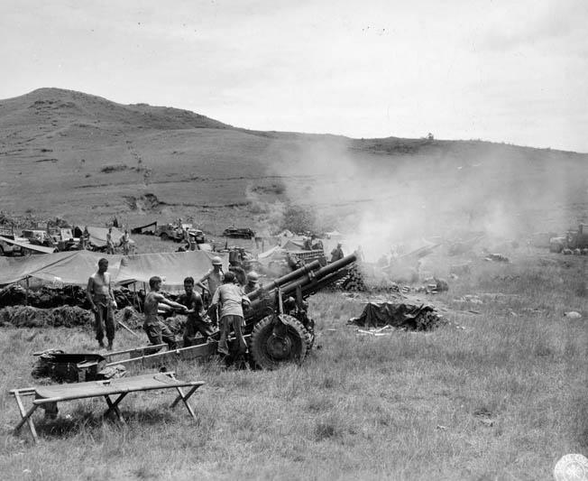 A 105mm artillery battery opens fire on Japanese positions.