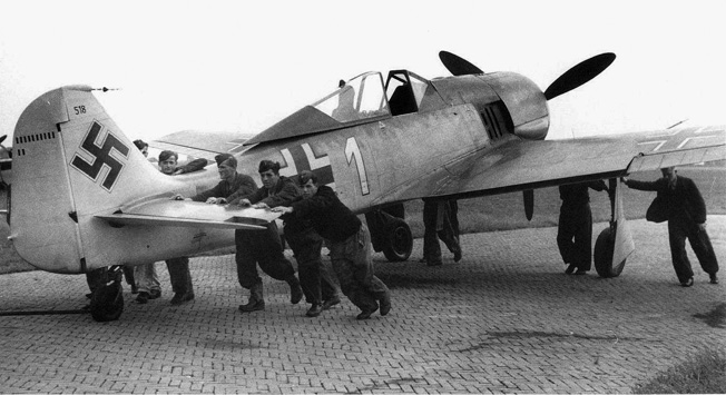 Luftwaffe ground crewmen push into position a Focke-Wulf Fw-190 of the type flown by the author.