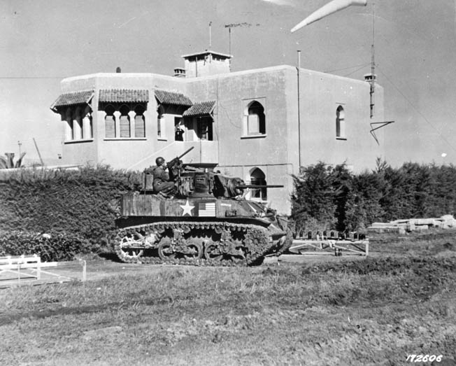 This Stuart light tank is equipped with a 37mm main weapon and a .30-caliber machine gun in the turret glacis for defense against enemy infantry. This photograph was taken in the city of Casablanca a few days after the Operation Torch landings. 