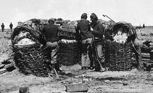 In this staged photograph, two Union pickets open fire, while another reloads behind an earthwork at Petersburg.