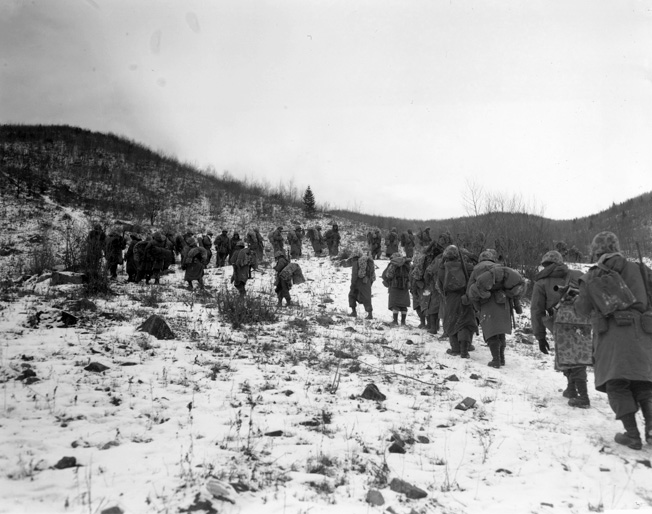 Marines trudge up a hill outside of Yudam-ni. These are probably the men of the 7th Marines moving in relief of one of the embattled perimeter companies.