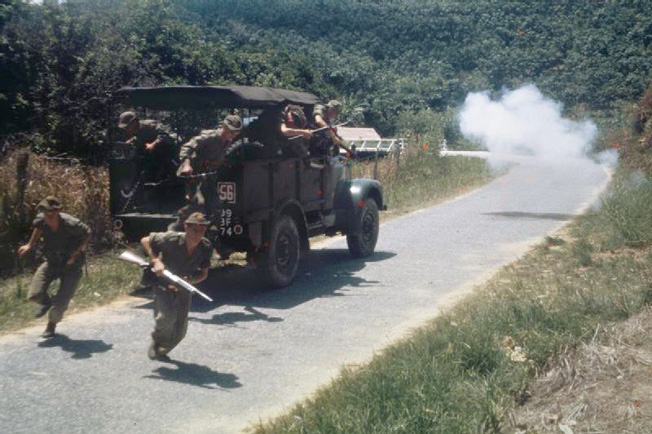 British troops dismount under fire after their patrol is ambushed on the road. 