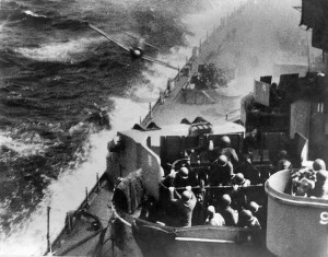 Naval gunners aboard USS Missouri work feverishly to take out a diving Japanese kamikaze before he strikes their ship.