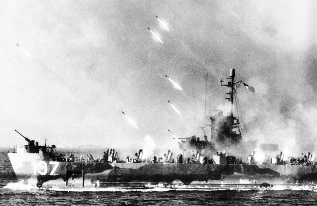 American warships support the amphibious landings by saturating Japanese positions with rockets and naval shells. Here a rocket gunboat unleashes a fusillade of explosives at the enemy. 