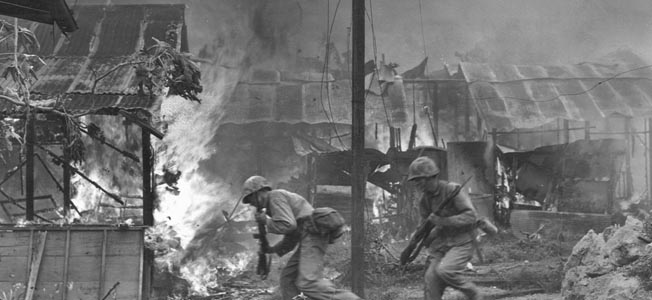 With rifles and flamethrowers at the ready, U.S. Marines blast caves and bunkers on Saipan with explosive charges. Any enemy troops that survived the concussion and attempted to escape were quickly cut down.