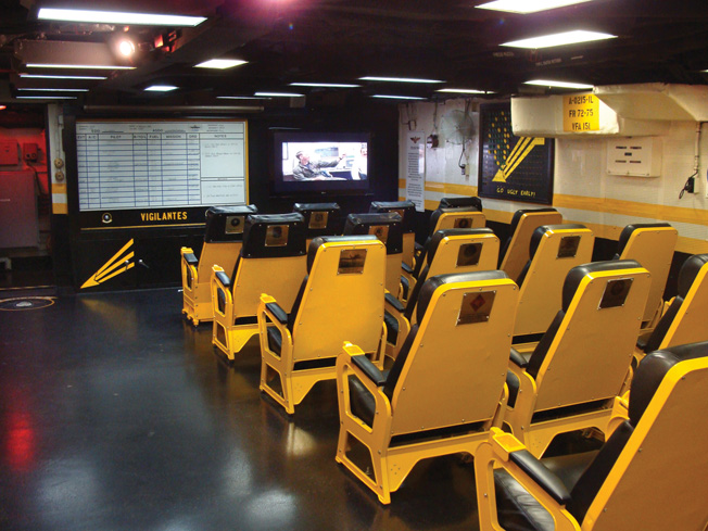 The squadron ready room contains the original seats pilots used during briefings. 