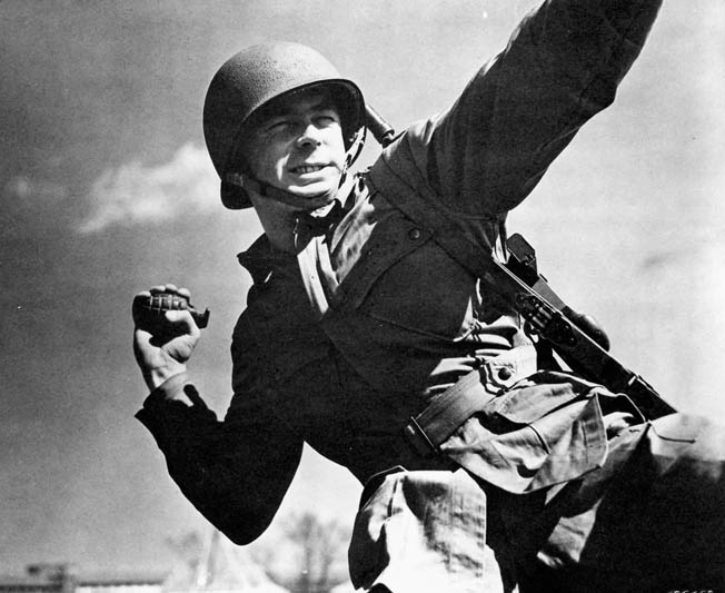An American infantryman training at Fort Belvoir prepares to hurl a pineapple grenade during World War II.