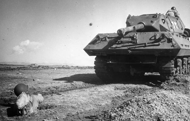 An American soldier hurls a grenade at a tank destroyer during commando training in 1943. Turning the body sideways and throwing overhead are essential to achieving accuracy.