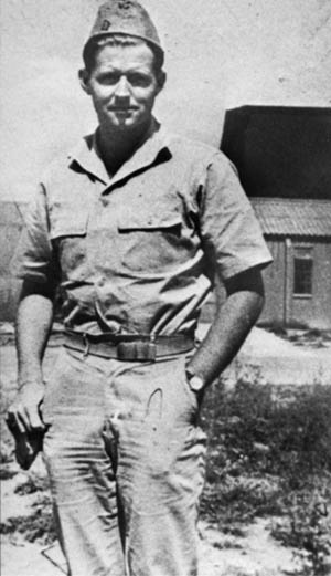 Lieutenant Joseph P. Kennedy, Jr., eldest son of the prominent Kennedy family, poses for a photo on the day of the mission during which he lost his life. This was the last image taken of the young officer.