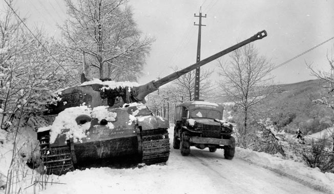 An Army ambulance rumbles by a knocked-out German Tiger Royal tank outside La Gleize, Belgium. Tigers terrified Miller and the tankers in his battalion. 