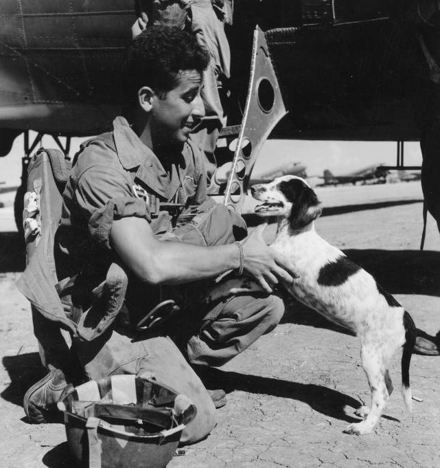 This photo shows "Jumper," ironically named because he didn't get to make the jump along with his paratrooper pals. To Jumper's left is paratrooper George R. Vespa of the 11th Airborne Division. The two said goodbye to one another before Vespa left for the Luzon Island jump. 
