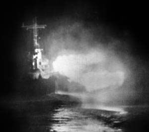 The light cruiser USS Honolulu fires at Japanese targets near Munda Point on the island of New Georgia in the Solomons. The Battle of Kula Gulf took place during operations to wrest the island from Japanese control.