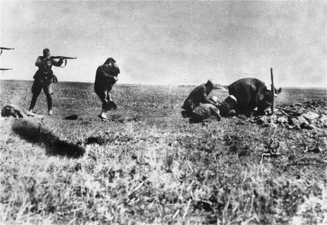 A member of Einsatzgruppe D executes a civilian. The unit, which followed behind German combat troops on the Eastern Front, was tasked with wiping out populations of Jews, Gypsies, partisans, and others. 