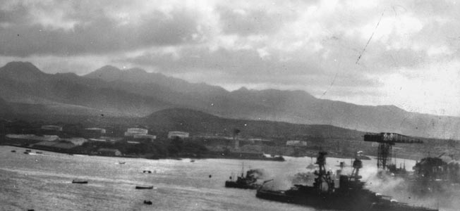 With smoke streaming from internal fires, Nevada tries to escape the Pearl Harbor killing zone and head out to sea. Moments after this photo was taken, the ship was hit by two Japanese bombs.With smoke streaming from internal fires, Nevada tries to escape the Pearl Harbor killing zone and head out to sea. Moments after this photo was taken, the ship was hit by two Japanese bombs.
