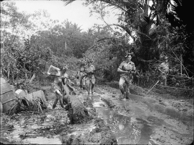 Australians patrol the muddy jungle around Milne Bay after the Japanese invasion was thrown back. Regulars and militia worked well side by side. 