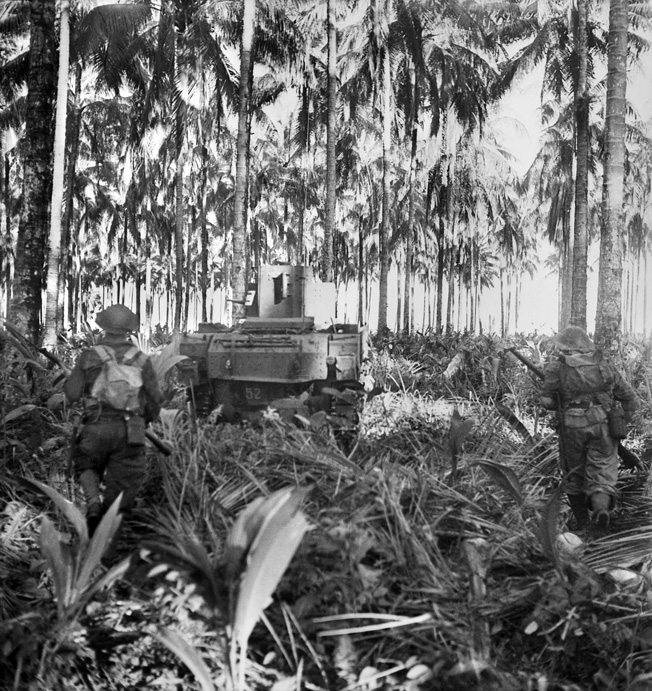 Australian infantrymen follow a tank leading the final assault on Buna, December 28, 1942. The Japanese defeat proved they were not supermen and gave the Allies hope of eventual victory no matter how far off.