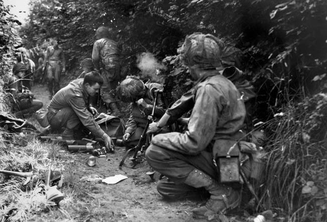 An American mortar team fires at the enemy from their hedgerow position. By swiftly adapting to the changing battlefield, American soldiers became a formidable fighting force by the end of the war.