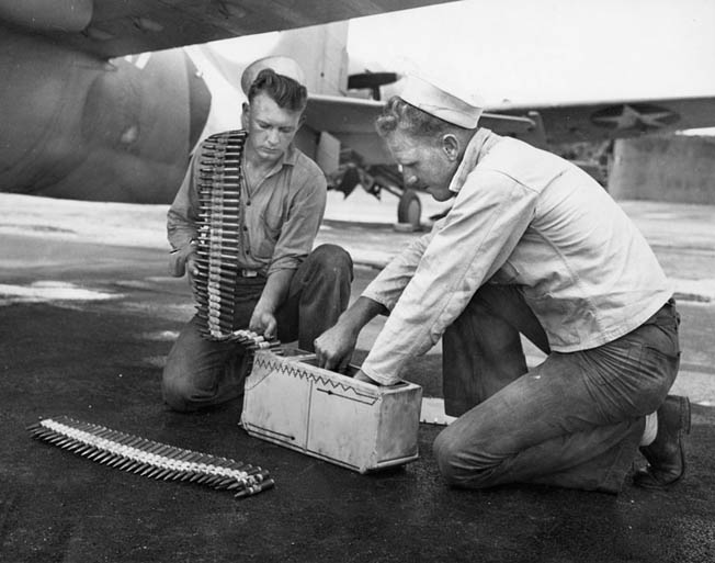 Carrier personnel load .50-caliber ammunition. Each of the Wildcat’s four guns held 450 rounds—only enough for 34 seconds of firing. 