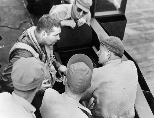 Lt. Cmdr. O’Hare (left) talks with leading crew chief “Chief Willy” Williams and others beside an F6F-3 Hellcat aboard the Enterprise after action over Wake Island, October 5, 1943. O’Hare vanished during combat over the Gilbert Islands on November 26, 1943. 