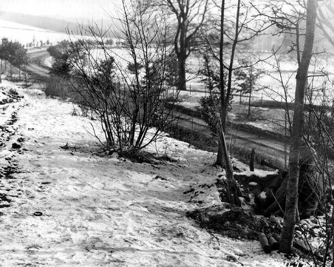 Manning a lonely outpost along a road leading into Bastogne, soldiers of the U.S. 101st Airborne Division point their bazooka in the direction of an expected German attack.