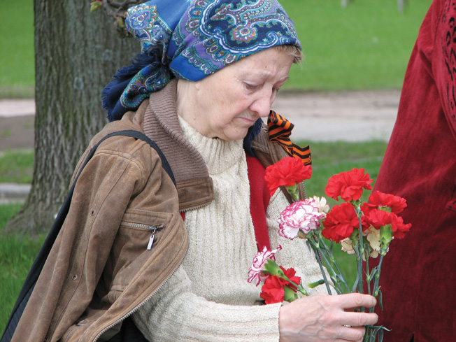 Leningrad is known to many as “the city of old women who survived the siege.” This woman pauses to remember lost family members and friends who perished during the siege that lasted nearly three years and caused tremendous suffering among the civilian population.