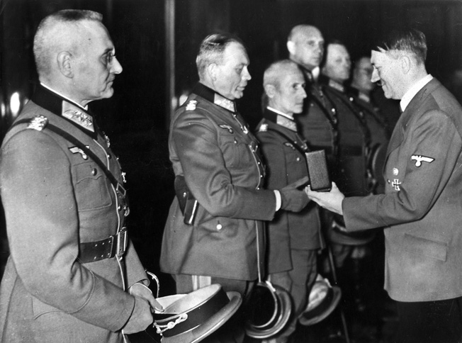 ADOLF HITLER (1889-1945). Chancellor of Germany, 1933-45. Awarding the Knight's Cross to generals Franz Halder, Heinz Guderian, Hermann Hoth, Adolf Strauss, Erich Hoepner and Friedrich Olbricht. Photograph, 27 October 1939.